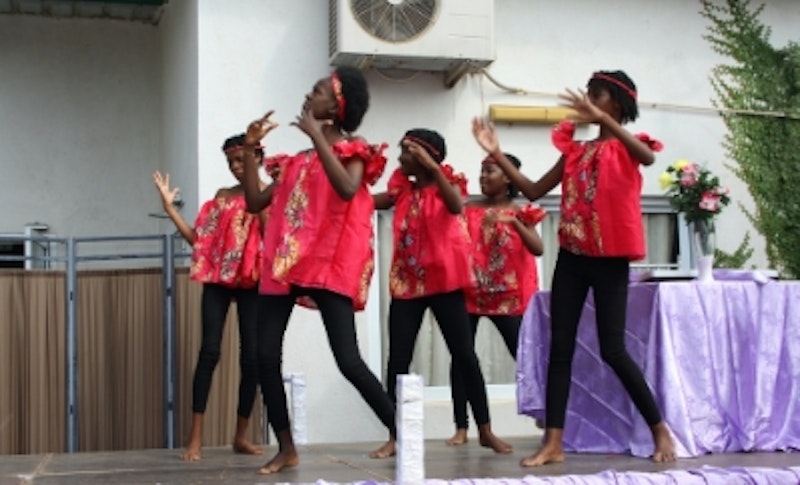 Young girls performing dance on a stage.