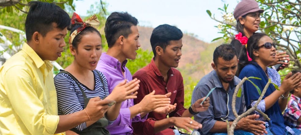 Group of seven youth singing together