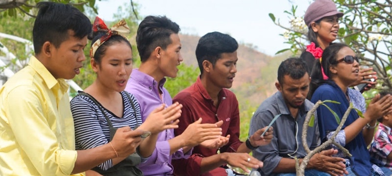 Group of seven youth singing together